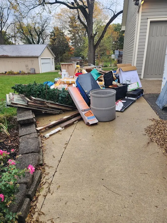 Dumpster being loaded with debris for Estate Cleanout Dumpster Rental in Southlake